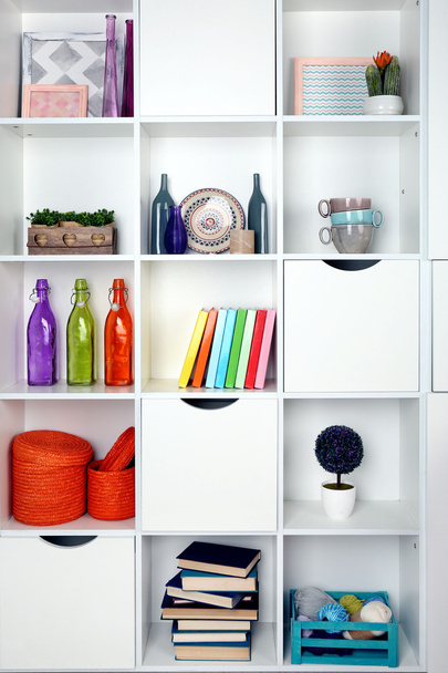 Beautiful white shelves with different home objects - Фото, зображення