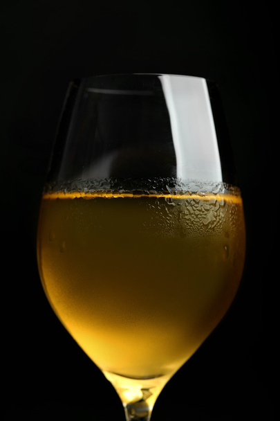 Glass of wine on dark background - Valokuva, kuva