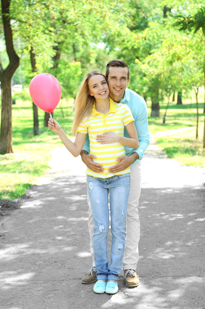 Young pregnant woman with husband in park - Фото, зображення
