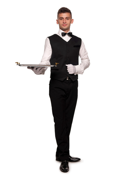 A young boy waiter with a tray - Фото, изображение