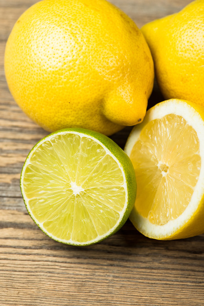 Fresh and juicy lemons and lime on a wooden surface - 写真・画像