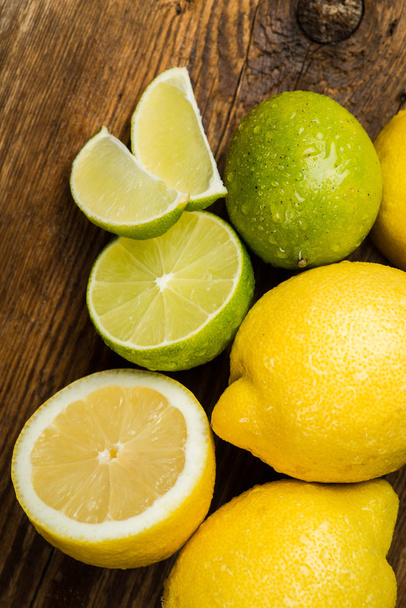 Fresh and juicy lemons and lime on a wooden surface - Photo, Image