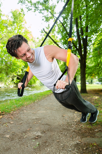 man doing suspension trainer sling sport - Fotoğraf, Görsel