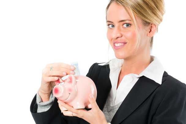 Geld besparen, vrouw met een piggy bank - Foto, afbeelding