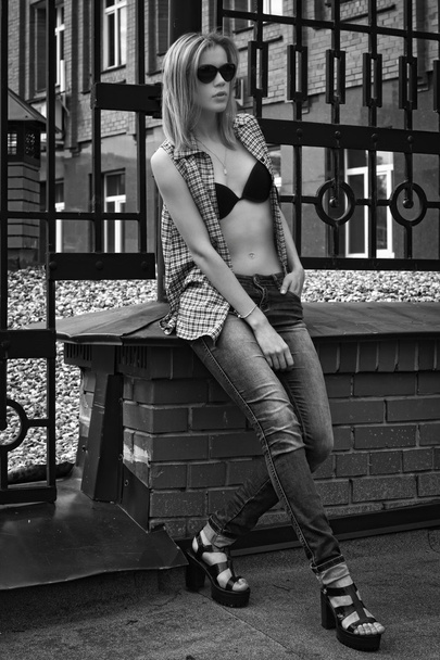Fashionable sexual young woman on the street - 写真・画像