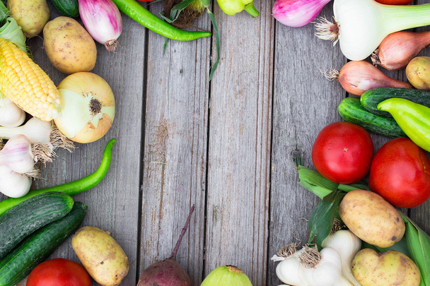 Harvest time. A basket of vegetables on a wooden table - Fotografie, Obrázek