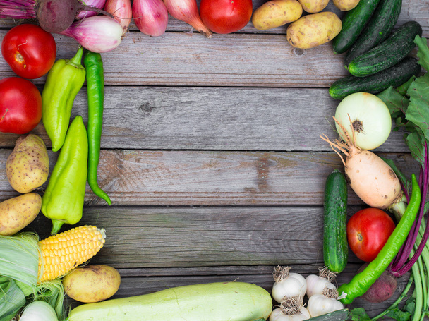 Harvest time. A basket of vegetables on a wooden table - Φωτογραφία, εικόνα