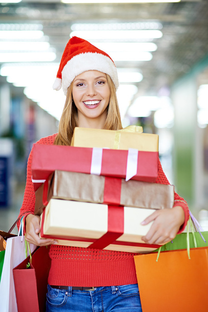Femme en chapeau de Père Noël avec des boîtes-cadeaux
 - Photo, image