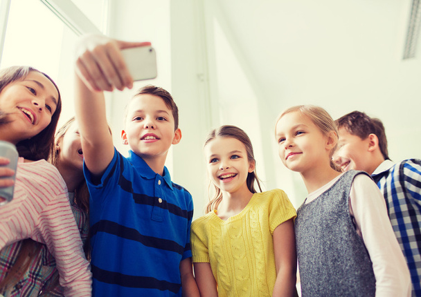group of school kids taking selfie with smartphone - Фото, изображение