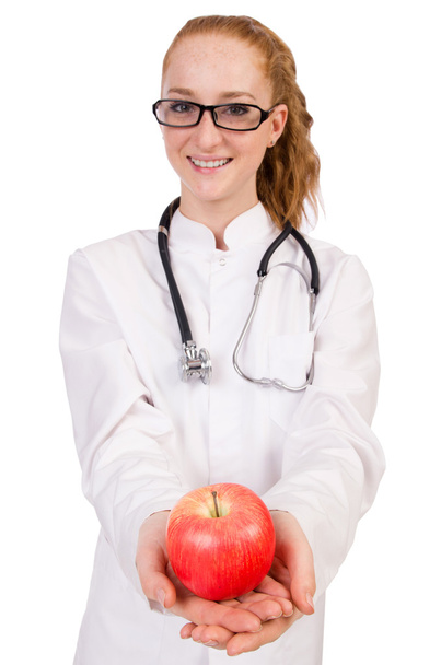 Bonita doctora con estetoscopio y manzana aislada
 - Foto, imagen