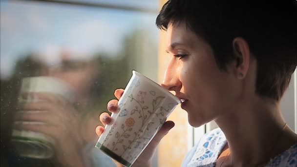beautiful woman sipping hot steaming drink - Footage, Video