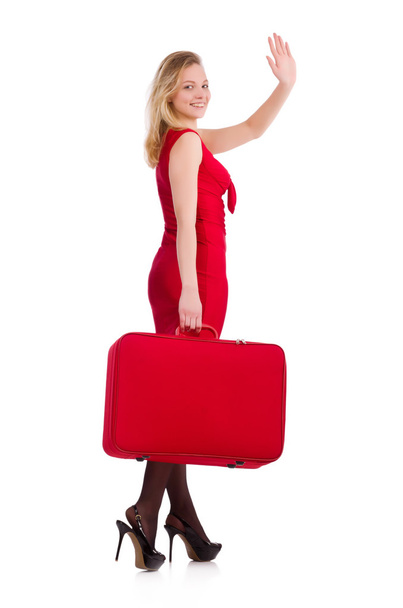 Uśmiechnięta kobieta w czerwonej sukience z walizką na białym tle - Zdjęcie, obraz