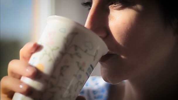 beautiful woman sipping hot steaming drink - Materiaali, video