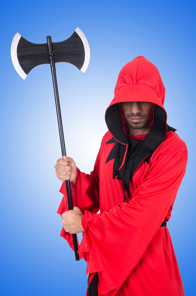 Executioner in red costume with axe on blue - Foto, immagini