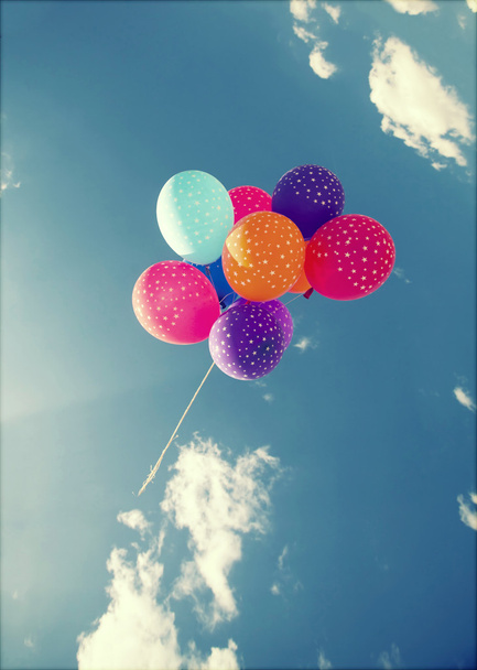 Colorful balloons flying on the blue sky - Fotoğraf, Görsel