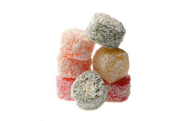 Sweets Turkish Delight, fruit jelly in coconut chips color on a white background - Photo, Image