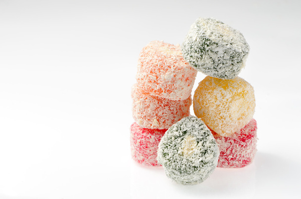 Sweets Turkish Delight, fruit jelly in coconut chips color on a white background - 写真・画像
