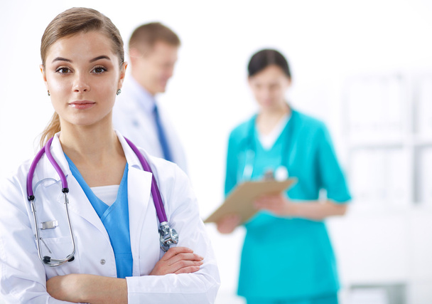 Attractive female doctor in front of medical group - 写真・画像