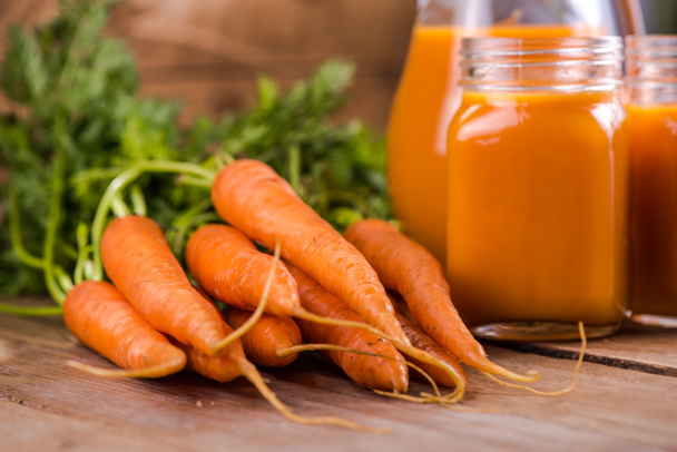 Carrot juice in mason jar on wooden background - Photo, Image