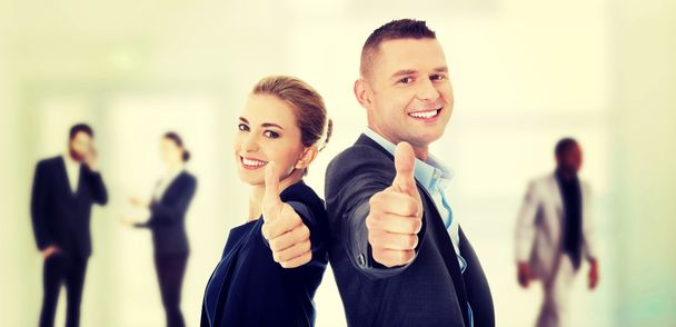 Business couple showing thumbs up - Photo, Image
