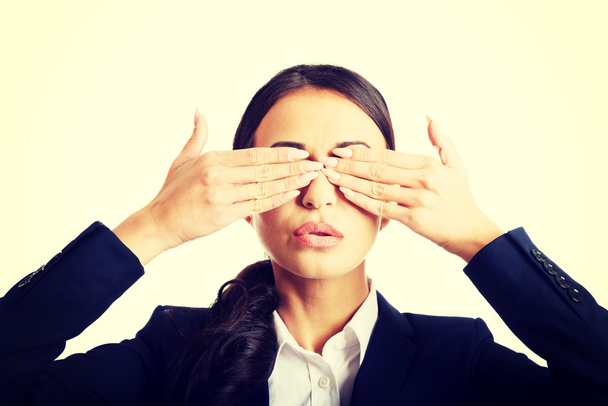 Portrait of businesswoman covering eyes with hands - Foto, Imagem