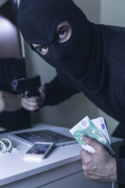 Burglar with handgun - Фото, изображение