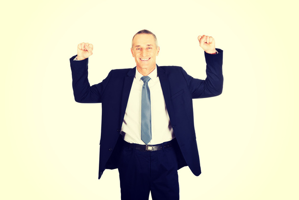 successful businessman with arms up - Foto, afbeelding