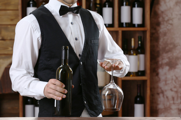 Bartender working at counter on bar background - Fotó, kép