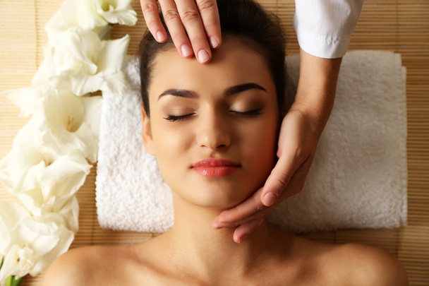 Young woman in beauty spa salon enjoying head massage - Fotografie, Obrázek