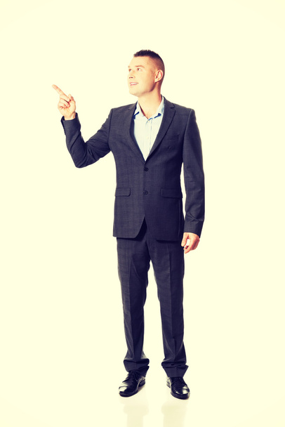 businessman pointing down - Foto, afbeelding
