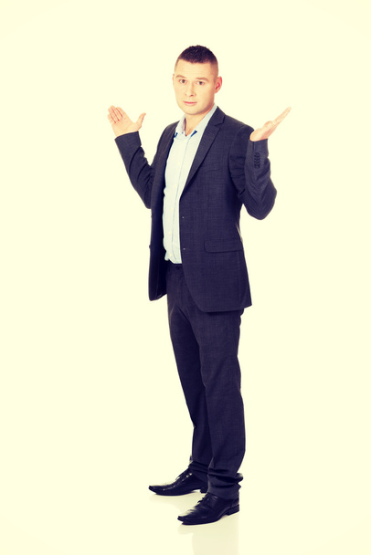 Businessman making undecided gesture - Foto, Imagen