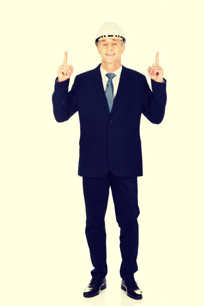 businessman with hard hat pointing up - Fotó, kép