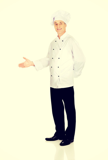 chef showing welcome gesture - Foto, Bild