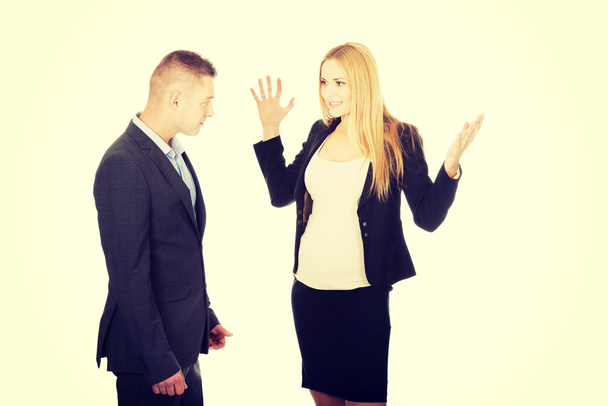 Pregnant businesswoman arguing with her partner - Fotó, kép