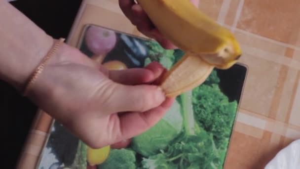 The girl cleans a banana. - Footage, Video
