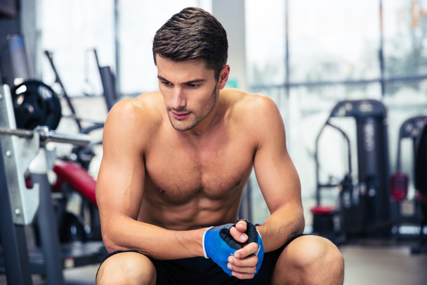 Man resting on the bench at gym - Photo, image