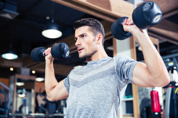Man workout with dumbbells at gym - Photo, Image