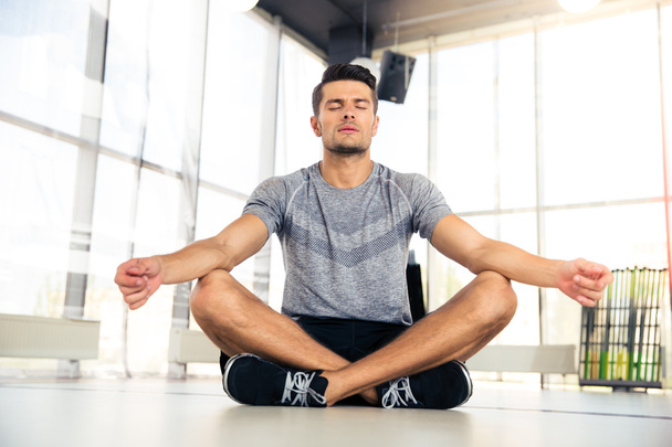 Man meditating in fitness gym  - Фото, зображення