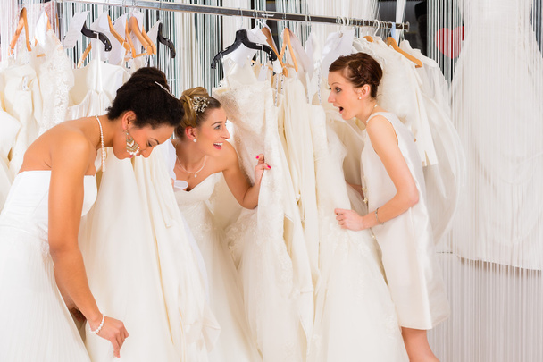 Women having fun during bridal dress fitting in shop - Valokuva, kuva