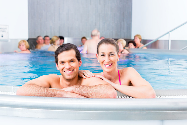 Couple bathing in swimming pool - Photo, Image