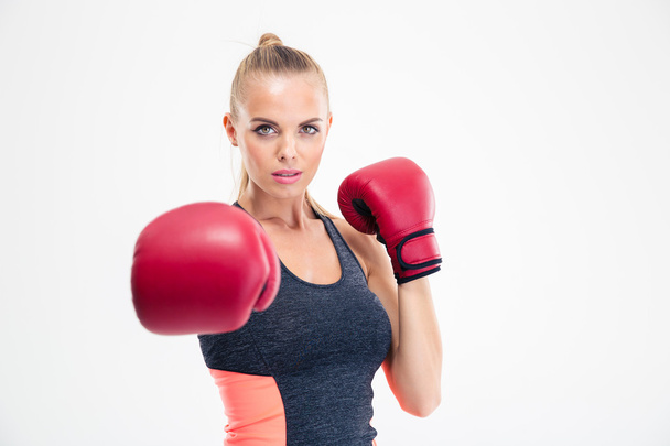 Woman hitting at camera in boxing gloves - 写真・画像