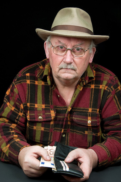 senior male with money issues on black background - Φωτογραφία, εικόνα