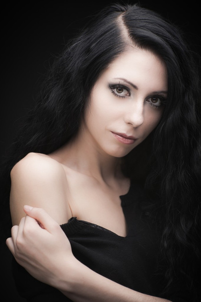 Young attractive gothic brunette woman over black - Fotografie, Obrázek