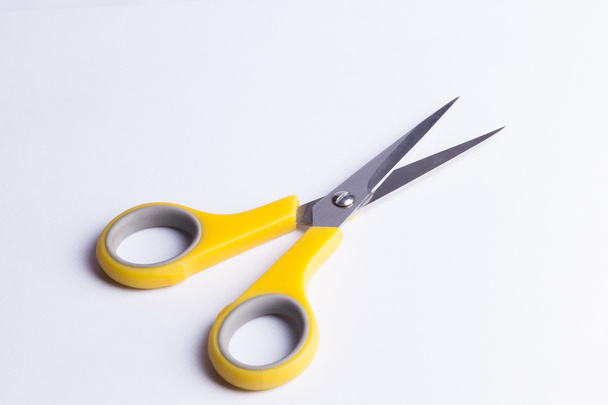 Yellow and grey scissors on white background - 写真・画像