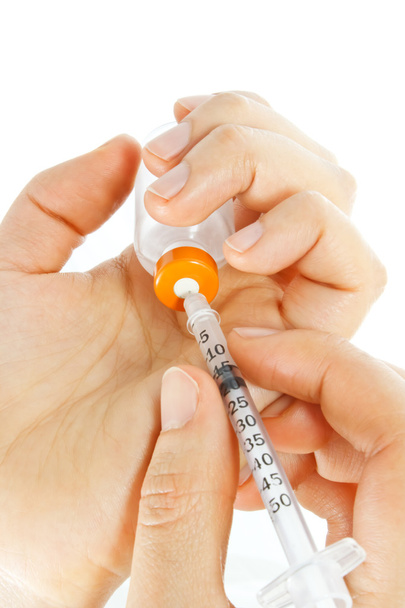 Hand holding syringe and vial - Фото, зображення