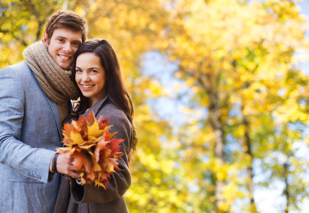 smiling couple hugging over autumn background - Zdjęcie, obraz