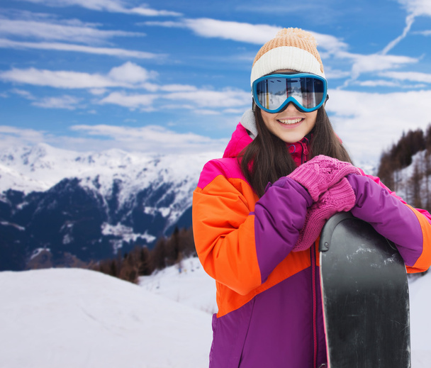 happy young woman with snowboard over mountains - Foto, immagini