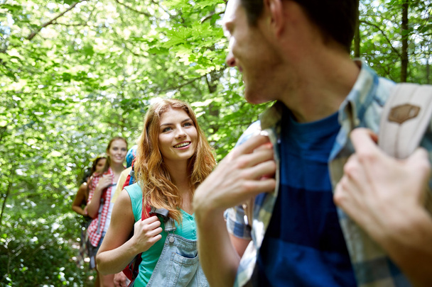 group of smiling friends with backpacks hiking - Foto, Bild
