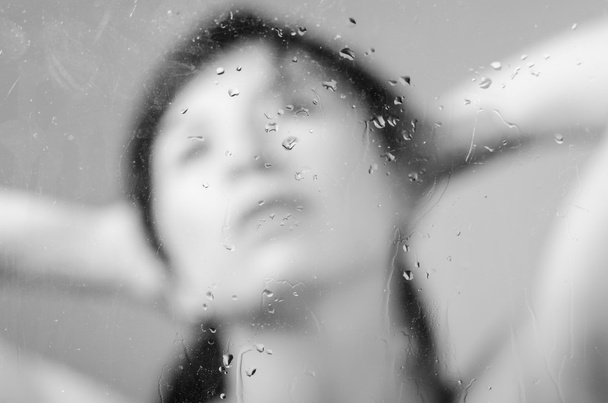 Closeup portrait of brunette girl behind glass - Foto, Imagen