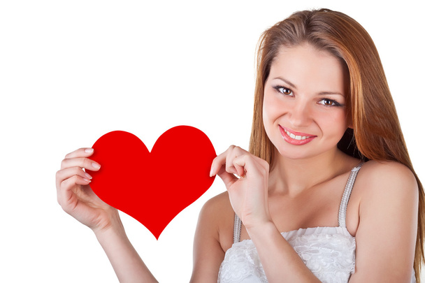 Sorrindo jovem mulher segurando um coração
 - Foto, Imagem